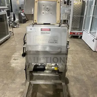 Goodnature commercial stainless steel hydraulic cold press juicer on casters, featuring clear "Danger" and brand labels.