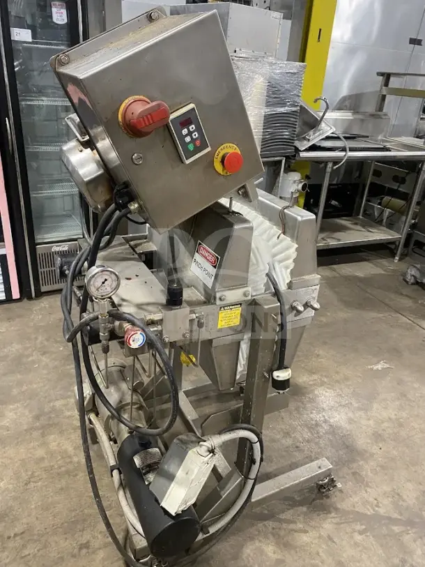Goodnature stainless steel hydraulic cold press juicer on casters, with control panel and safety labels, used condition.