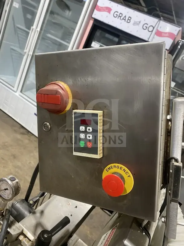 Goodnature Commercial Stainless Steel Hydraulic Cold Press Juicer with control panel and emergency stop button, on casters.