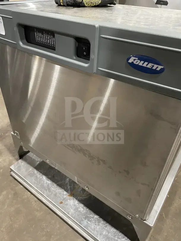 Follett stainless steel under-counter ice storage bin/dispenser base, durable condition, visible controls and branding.