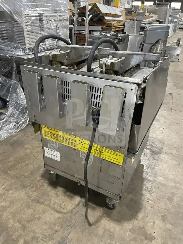 Garland XPG24 stainless steel natural gas clamshell griddle, dual platens, back and side splashes, on casters, 24".