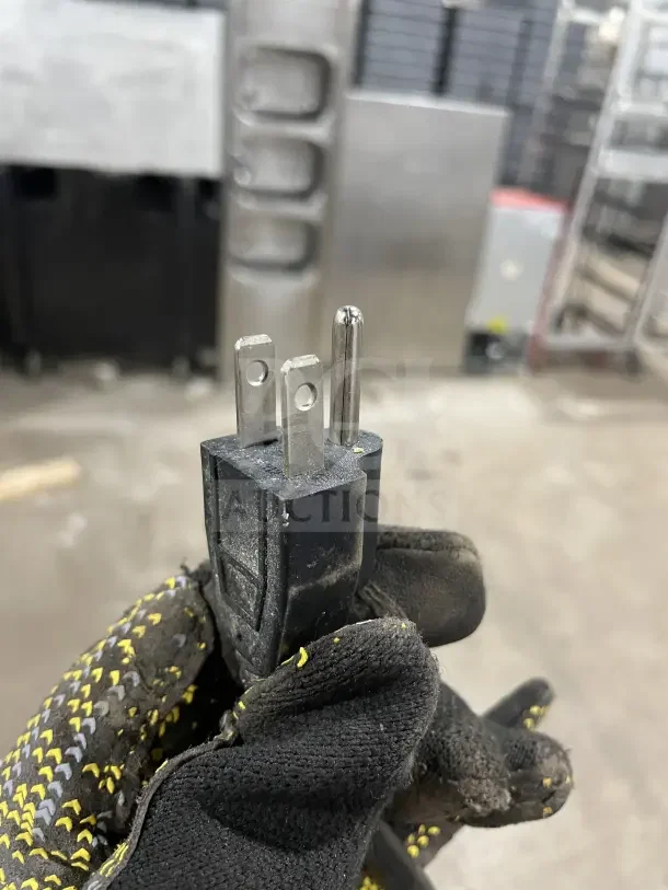 A close-up of a three-prong power plug for a 2018 commercial heavy-duty electric mixer, Model HL-B20M, SN: 18HL7145020.