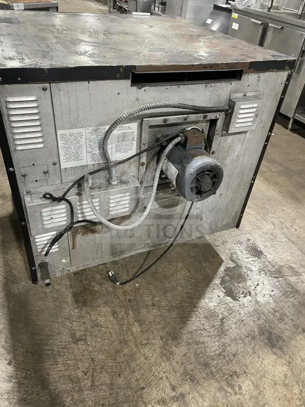 Sunfire commercial stainless steel gas convection oven, single stack, with wire rack. Visible labels and wiring on the back.