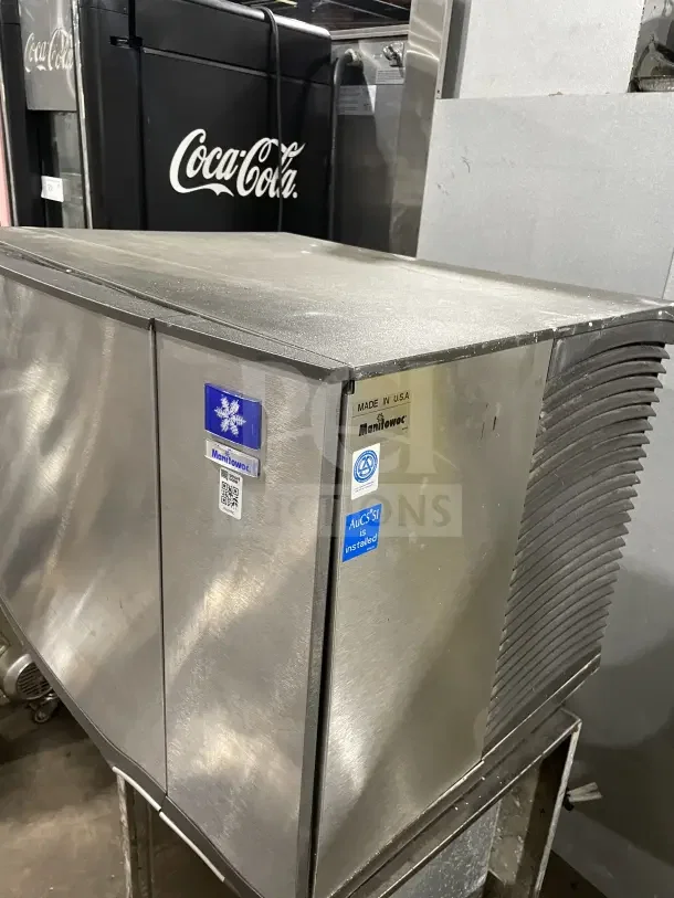 Manitowo SD0452A stainless steel electric ice maker, lift-open access, on legs, made in USA, with brand and model labels.
