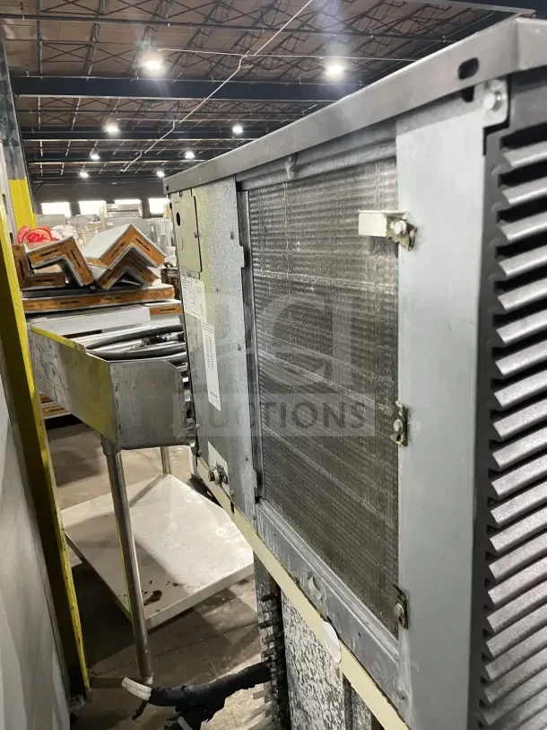 Manitowo SD0452A stainless steel ice maker, electric-powered, lift open access, on legs, industrial setting.