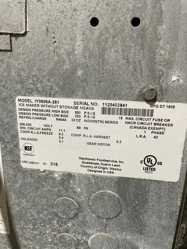 Manitowoc commercial stainless steel ice machine head, model IY0606A261, SN: 1120402941, with label details.