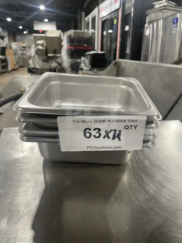 Amko stainless steel half-size steam table pan, model 24602. Appears in good condition, with visible auction label.