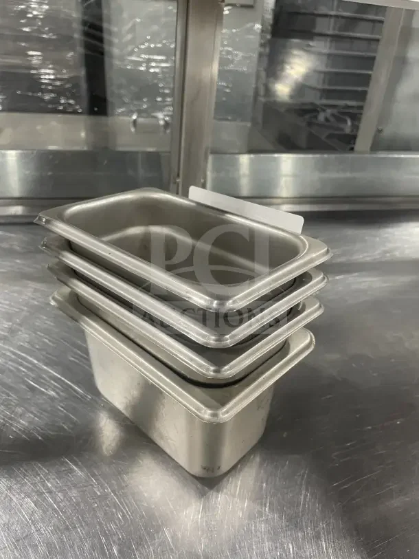 Winco SPN4 stainless steel half-size steam table pan, stacked set, commercial grade, good condition, visible slight wear.