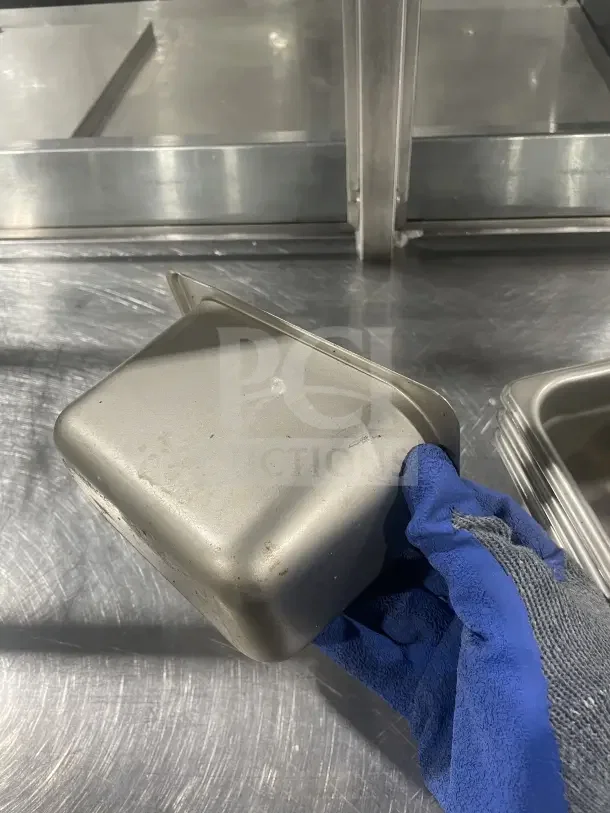 Winco stainless steel half-size steam table pan, model SPN4. Clean with minimal wear. Ideal for commercial use.