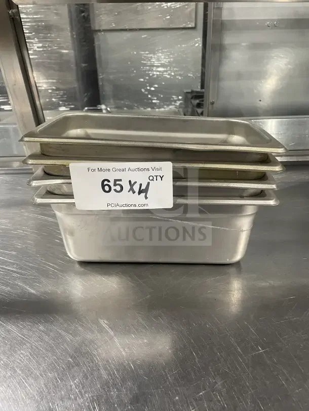 Winco commercial stainless steel half-size steam table pan model SPJL404, stack of four, lightly used, auction label visible.