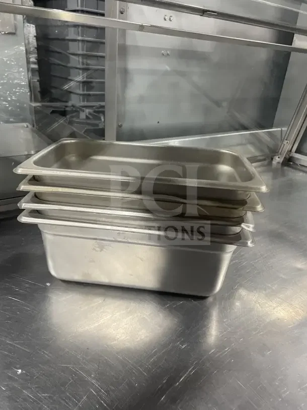 Winco SPJL404 half-size stainless steel steam table pan, stacked, commercial grade, used condition, sleek finish.