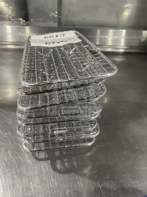 Vollrath Commercial Stainless Steel Super Pan 1/3 Size Wire Pan Grate, stack of grates on stainless surface, excellent condition.