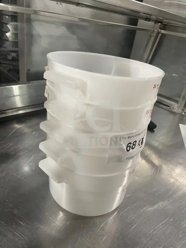 Cambro RFS2148 white round polypropylene food containers, stack of four, new condition, with side handles and auction label.
