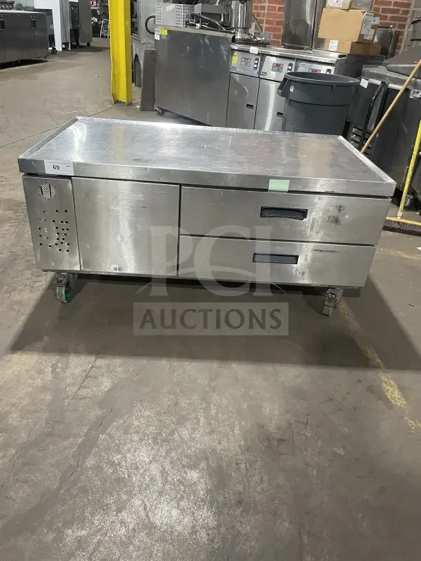 Commercial stainless steel refrigerated chef base with single door and two drawers on casters. Used condition.
