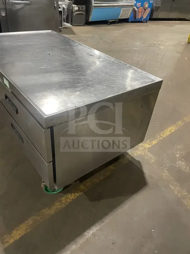 Commercial stainless steel single door, 2-drawer refrigerated chef base on casters. Slightly worn surface.
