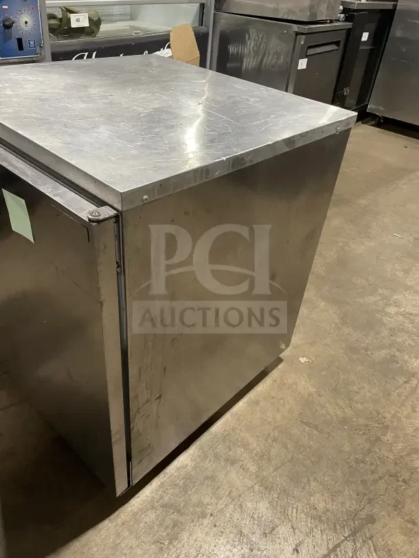 Delfield Enodis Series 27" stainless steel undercounter refrigerator, Model 406CA-DD1, on casters, with poly coated rack.