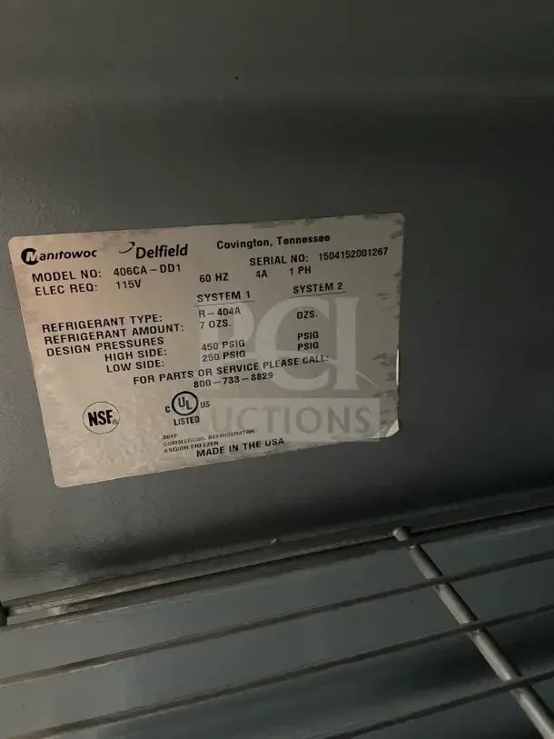 Delfield Enodis stainless steel undercounter refrigerator, model 406CA-DD1, with poly-coated wire rack. Serial 0406036100311-T, 115V, on casters.