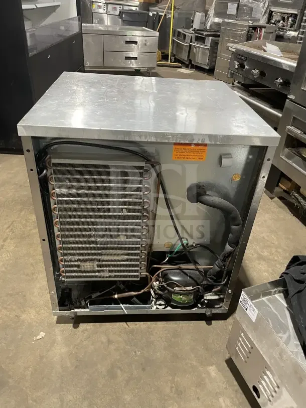 Delfield Enodis Series single door undercounter refrigerator, model 406CA-DD1, stainless steel, 27", poly-coated rack, on casters.