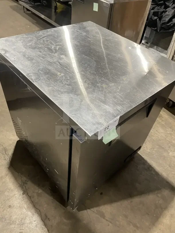 True TUC27LP commercial stainless steel single door lowboy cooler. Visible wear. Model and serial number labels attached.
