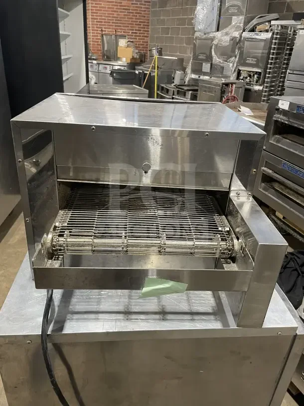Avantco TTP14240 stainless steel conveyor pizza oven, countertop model, gently used, visible power cord, commercial kitchen setting.