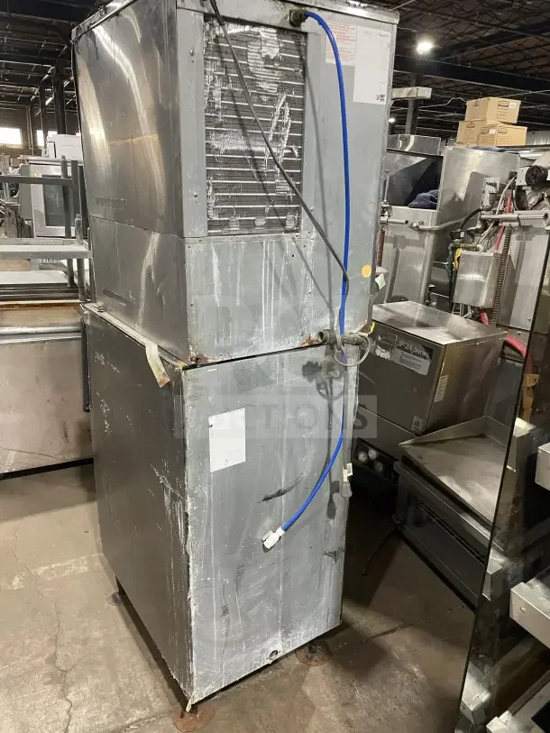 Hoshizaki commercial stainless steel ice machine with modular design, storage bin, on legs, shown with visible wear.