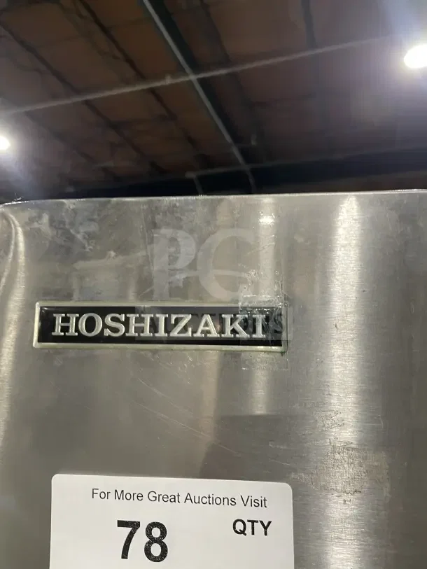 Hoshizaki commercial stainless steel slim-line ice machine with storage bin, on legs. Features visible Hoshizaki branding.