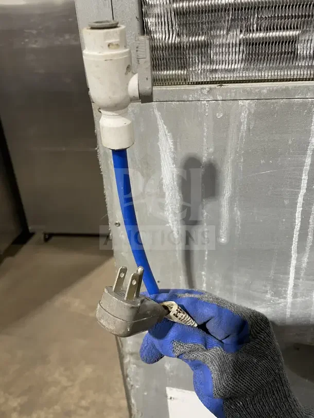 Hoshizaki stainless steel modular ice machine with storage bin, shown with power plug and water line, in good condition.