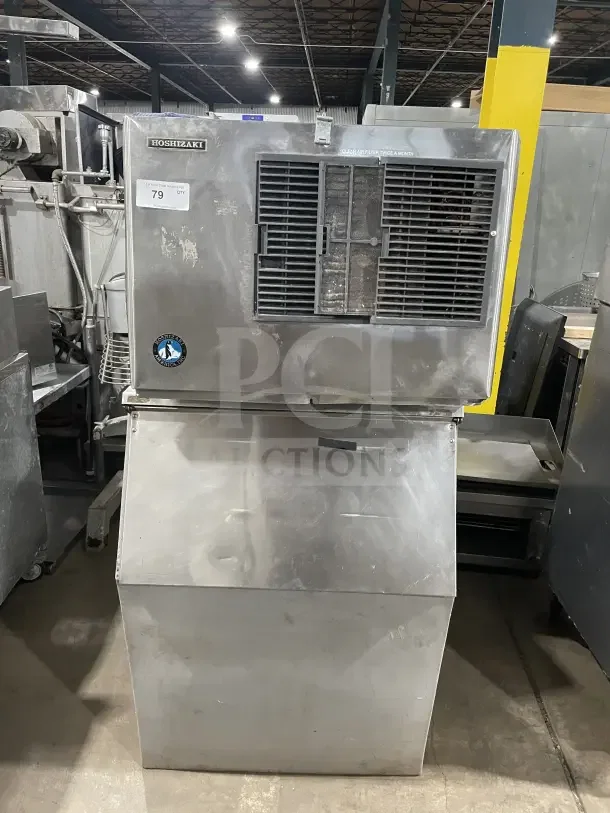 Hoshizaki commercial stainless steel air-cooled modular ice machine with storage bin. Features visible brand label and tag.