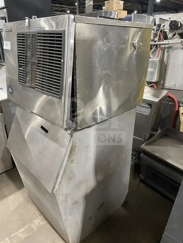 Hoshizaki modular ice machine with storage bin, stainless steel, air-cooled, dents on surface, label reads "clean filter twice a month."