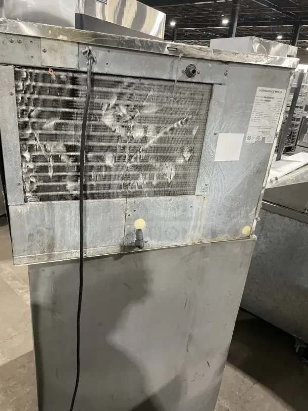 Hoshizaki commercial ice machine, stainless steel, air-cooled, with storage bin, used condition, visible labeling.