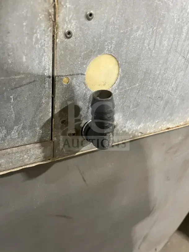 Hoshizaki stainless steel air-cooled modular ice machine with storage bin. Displays signs of wear, with visible vents and hose connection.