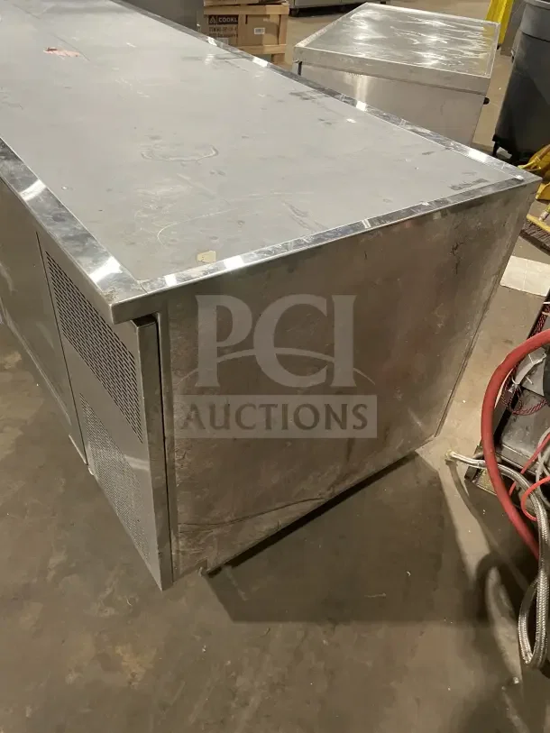 Commercial stainless steel bench fridge with 3 glass doors, model RF CSY0702, on casters. Used condition, visible wear.