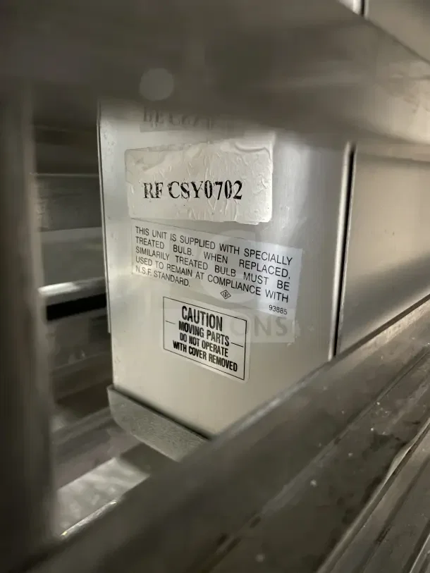 Commercial stainless steel 3-door fridge, model RF CSY0702. Features gastronorm design on casters, visible caution and compliance labels.