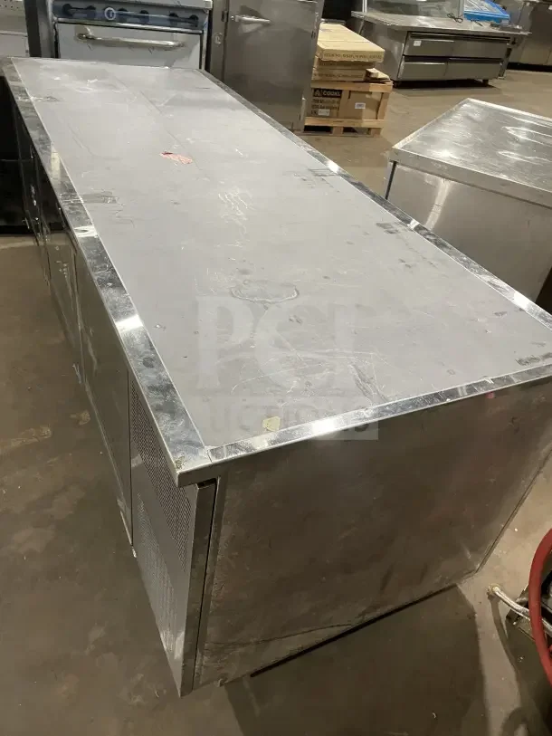 Commercial stainless steel fridge, model RF CSY0702, with three glass doors and casters. Used condition with visible wear.