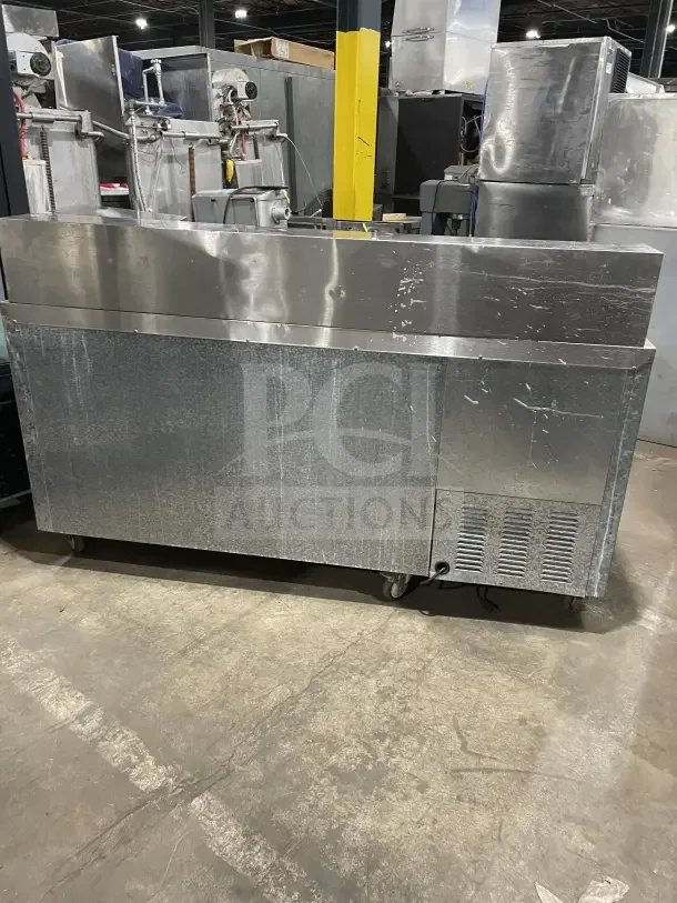 Leader LM72 stainless steel 3-door refrigerated prep table on casters. Features poly-coated wire rack. Model: LM72 SN: PQ012493.