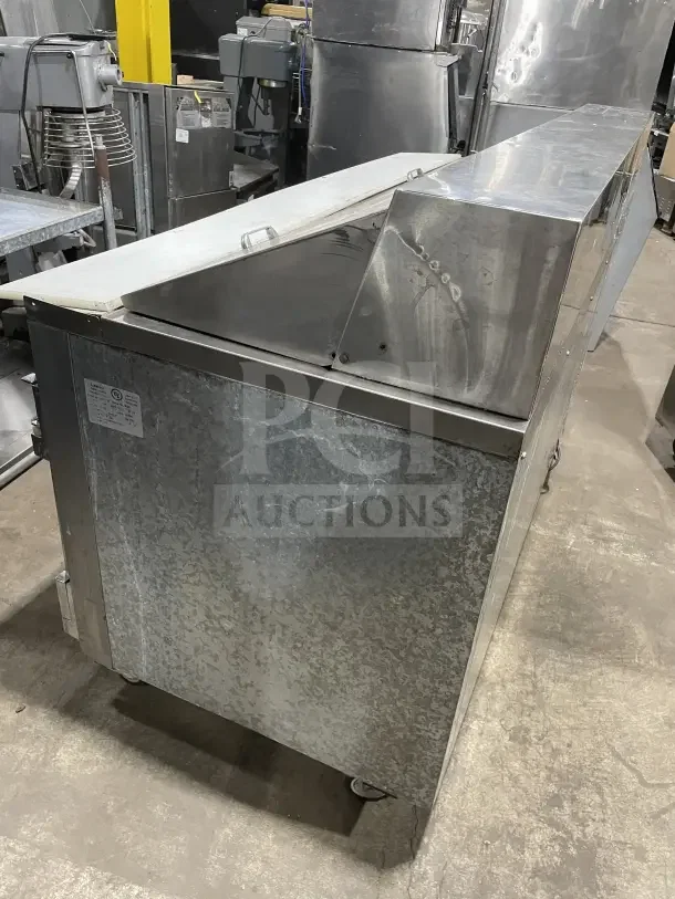 Leader LM72 stainless steel three-door refrigerated bain marie prep table, on casters, poly coated wire rack, model SN: PQ012493.