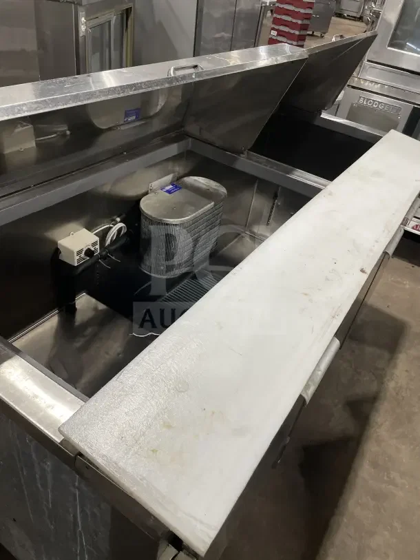 Leader LM72 commercial stainless steel 3-door refrigerated prep table with open top, poly-coated wire rack, and casters.