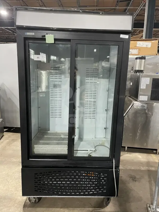 Frigoglass MC1100S-1 black commercial refrigerator, double glass sliding doors, poly coated wire rack, casters, good condition.