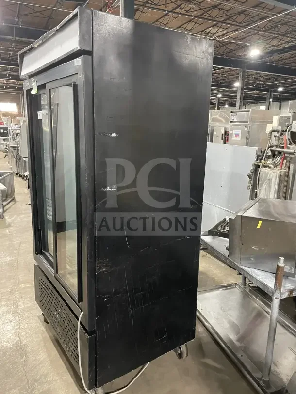 Frigoglass MC1100S-1 commercial black double glass sliding door merchandiser refrigerator on casters, with poly coated wire rack.