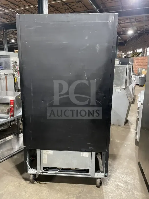 Frigoglass commercial black double glass sliding door merchandiser refrigerator, Model MC1100S-1, on casters, rear view.