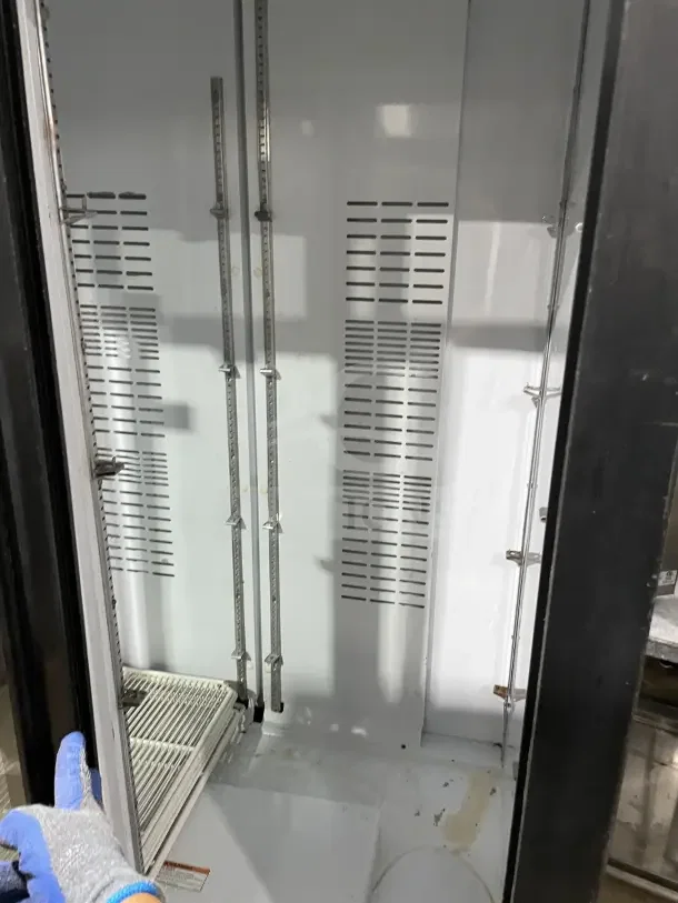 Frigoglass MC1100S-1 commercial black double glass sliding door refrigerator, featuring poly coated wire racks, on casters.