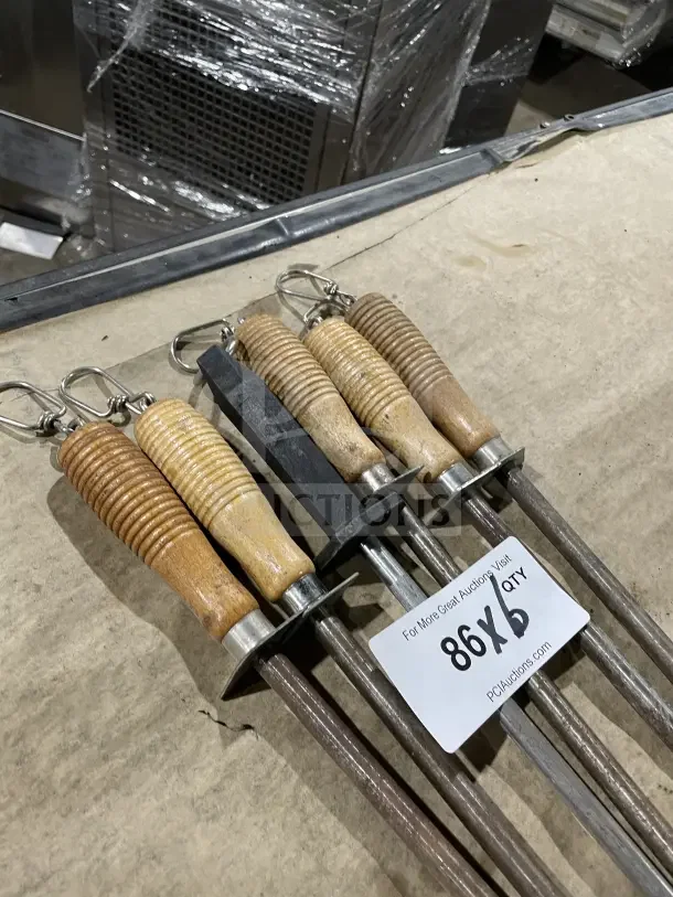 Commercial lot of six kitchen knife honing steels with ribbed wood and composite handles, showing light usage wear.