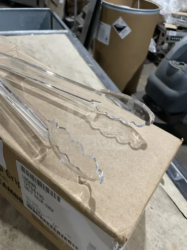 Cambro Lugano 12" clear polycarbonate scallop grip tongs on box. New condition, commercial-grade, 12X bid quantity.