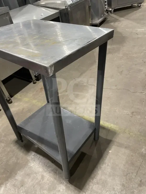 Commercial stainless steel equipment stand on legs, features durable construction, used condition.
