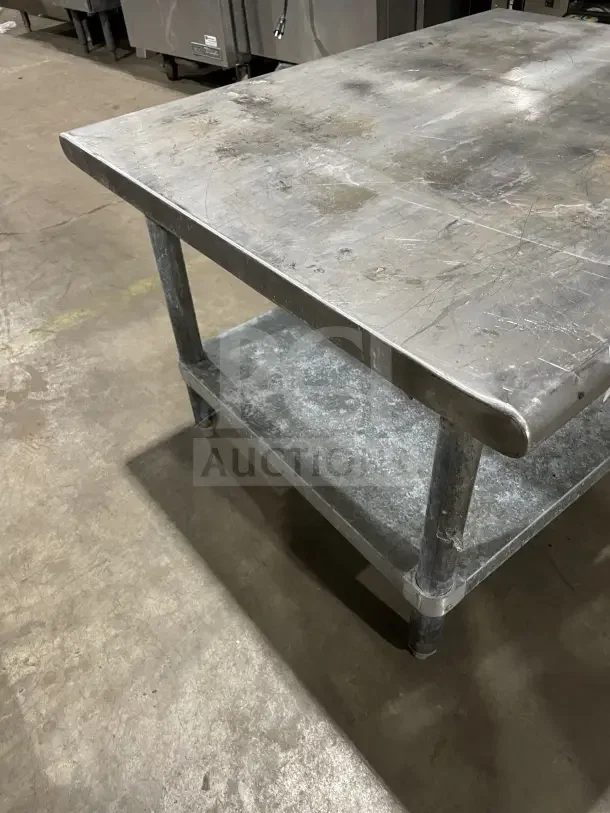 L&J Commercial Stainless Steel 2 Compartment Equipment Stand with sturdy legs, showing mild wear. Ideal for industrial use.