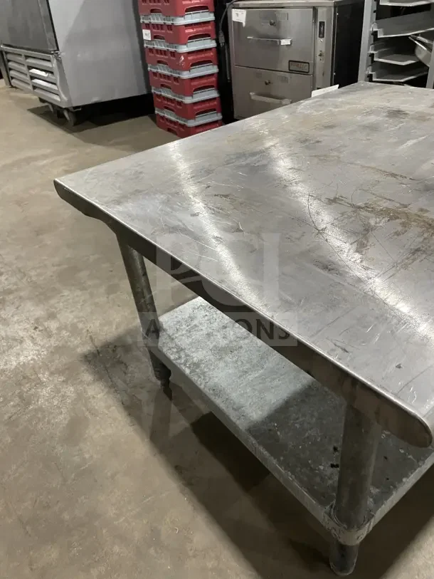 L&J Commercial stainless steel 2-compartment equipment stand with legs. Features lower shelf and visible surface wear.