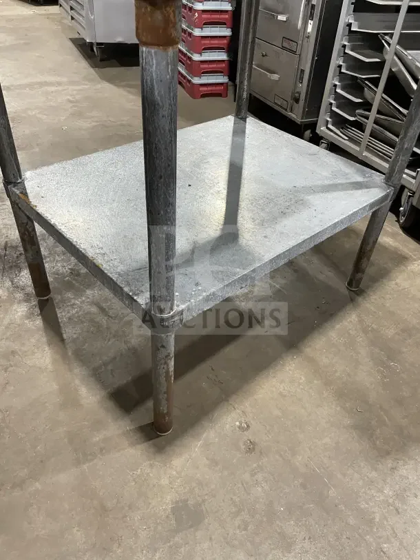 Commercial stainless steel 2 compartment equipment stand on legs, showing minor wear, ideal for kitchen or restaurant use.