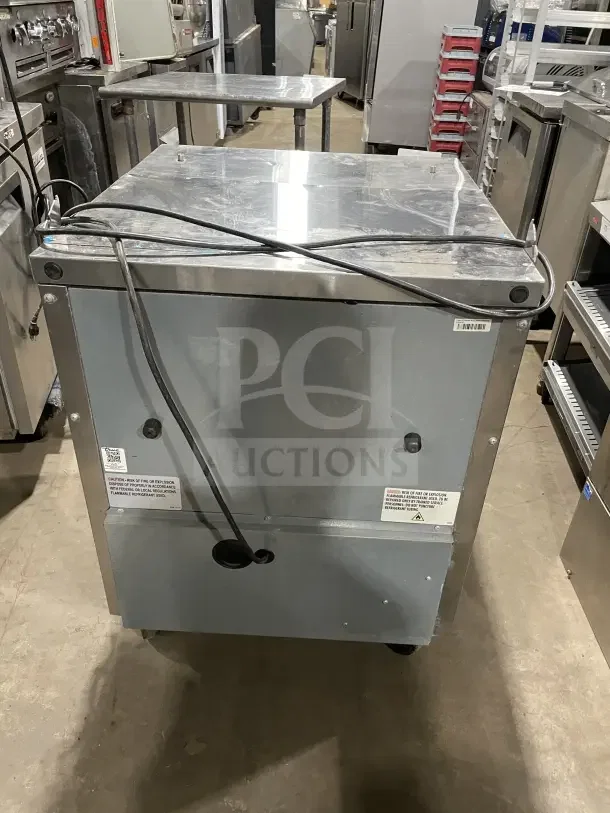 True commercial stainless steel single door refrigerated prep table, model TSSU-27-08-HC, on casters, with poly coated wire rack.