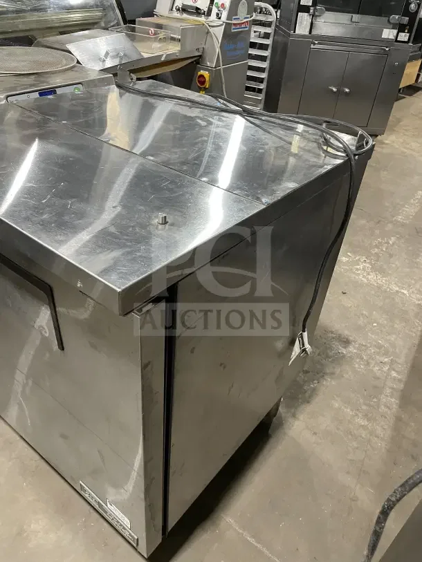 True TSSU2708HC single door stainless steel prep table with poly coated wire rack, on casters, model 9146426, 115V, commercial use.