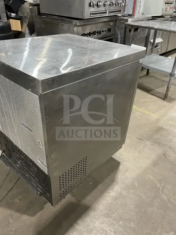 Coldline 27" stainless steel undercounter refrigerator, model UUC27RHC, features poly-coated wire rack, good condition.
